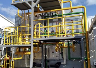 A large yellow and green structure with pipes.